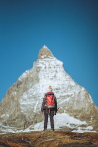 Person standing in front of a mountain - what stops you from reaching your goals